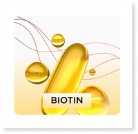 Gold biotin supplement capsule with droplets on a white background